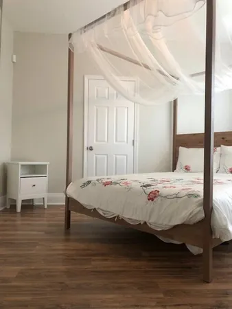 a bed sitting in a bedroom next to a window