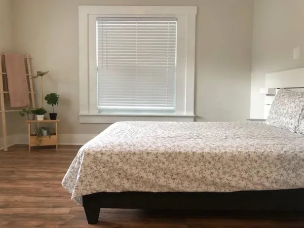 a bedroom with a bed and a window