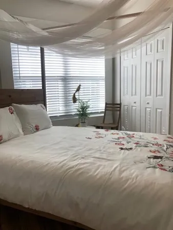 a living room with furniture and a mirror