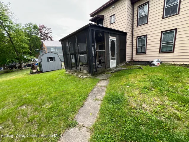 a view of a house with yard and a tree