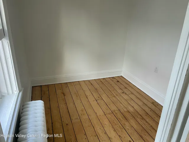 a view of wooden floor in an empty room