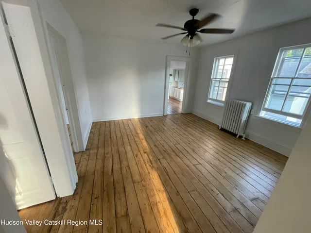 wooden floor in an empty room with a window