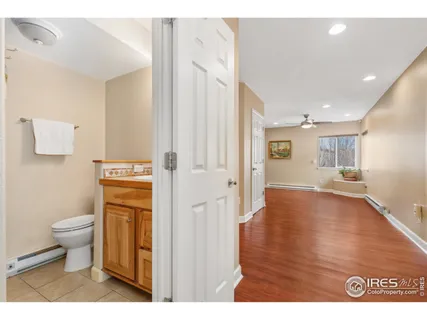 a bathroom with a toilet sink a mirror and vanity