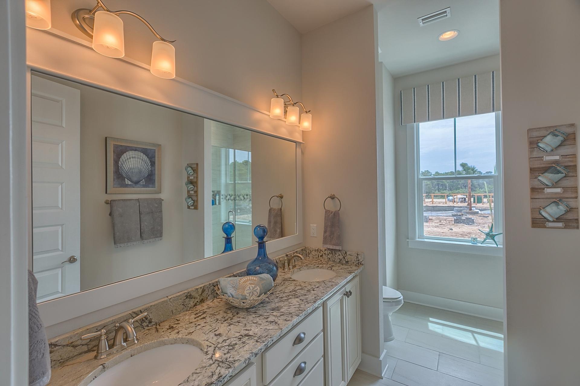 189 Milestone Dr Inlet Beach, Unit 189 Inlet Beach, FL 32461 - Photo 4 of 32 a bathroom with a granite countertop sink and a mirror