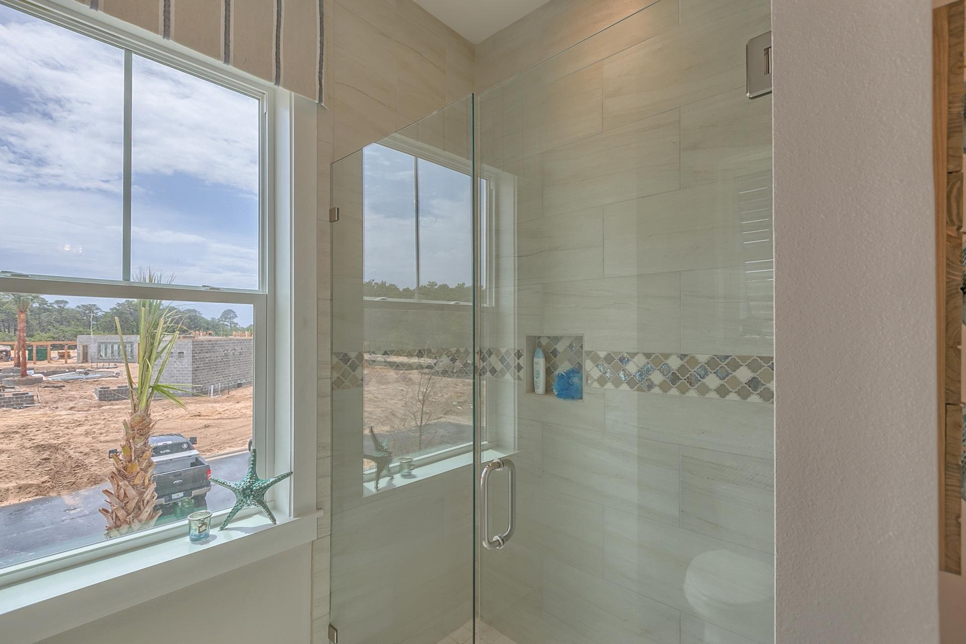 189 Milestone Dr Inlet Beach, Unit 189 Inlet Beach, FL 32461 - Photo 5 of 32 a bathroom with a glass shower door