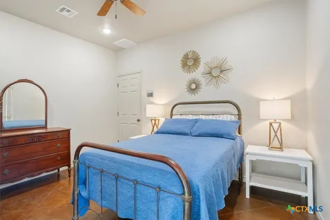 a bedroom with a bed and a chandelier