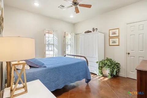 a living room with a bed and a chandelier
