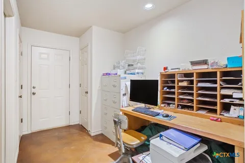 a view of a workspace with furniture