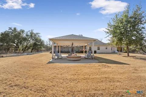 a view of a house with swimming pool and sitting area
