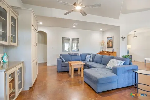 a living room with furniture and a chandelier