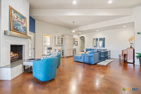 a living room with furniture wooden floor and a fireplace