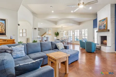 a living room with fireplace furniture and a wooden floor