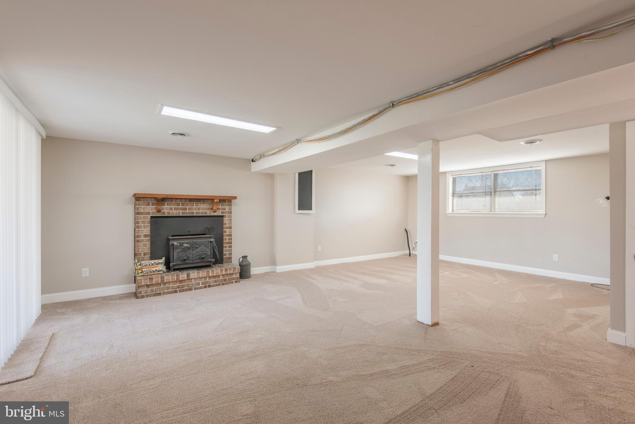 157 Cedar Swamp Road Townsend, DE 19734 - Photo 24 of 49 FINISHED LOWER LEVEL WITH WOOD STOVE