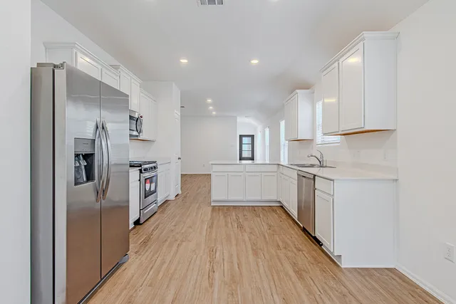 a view of a kitchen with wooden floor