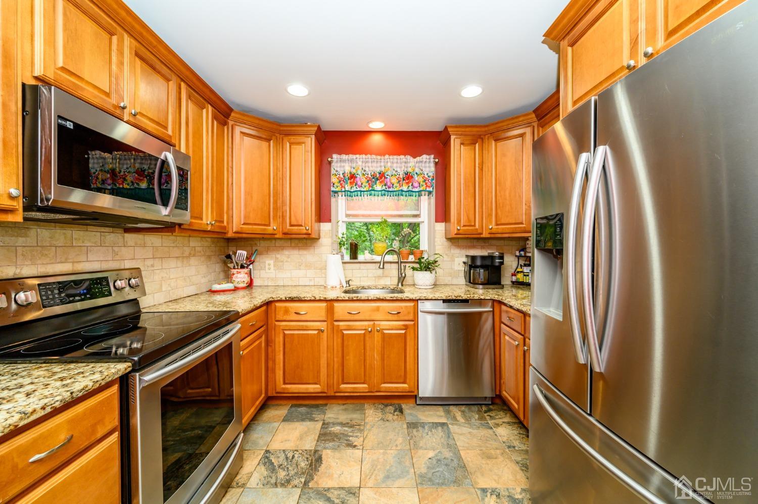 67 Hollow Road Glen Gardner, NJ 08826 - Photo 12 of 45 a kitchen with stainless steel appliances granite countertop a refrigerator a stove top oven a sink and dishwasher