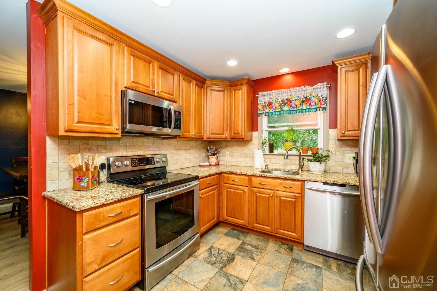 67 Hollow Road Glen Gardner, NJ 08826 - Photo 13 of 45 a kitchen with stainless steel appliances granite countertop refrigerator a stove top oven a sink and dishwasher