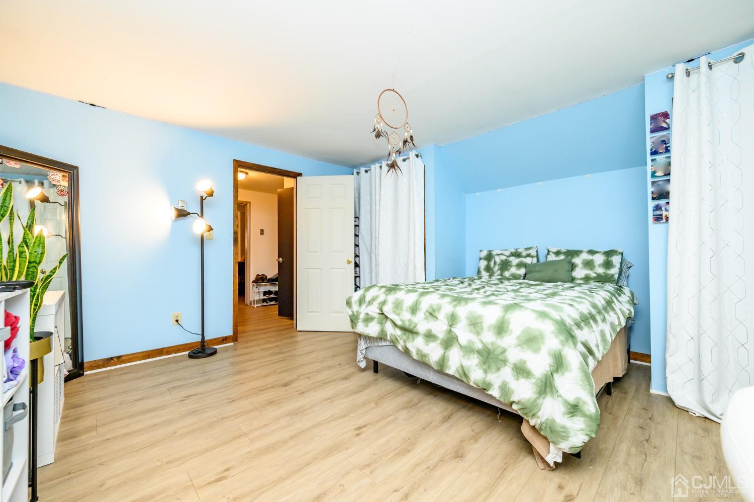 67 Hollow Road Glen Gardner, NJ 08826 - Photo 30 of 45 a bedroom with a bed and a flat screen tv