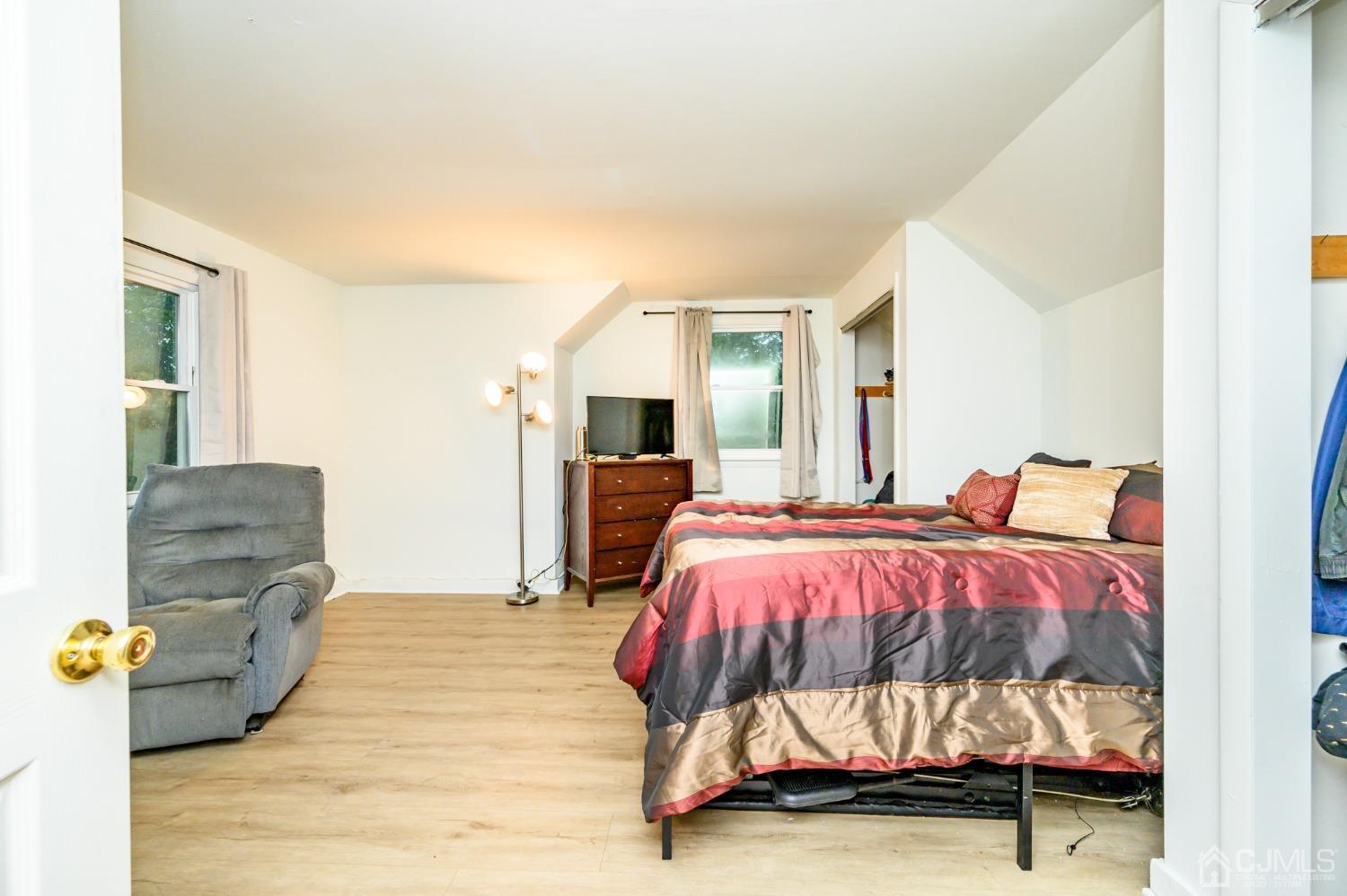 67 Hollow Road Glen Gardner, NJ 08826 - Photo 32 of 45 a bedroom with a bed and wooden floor