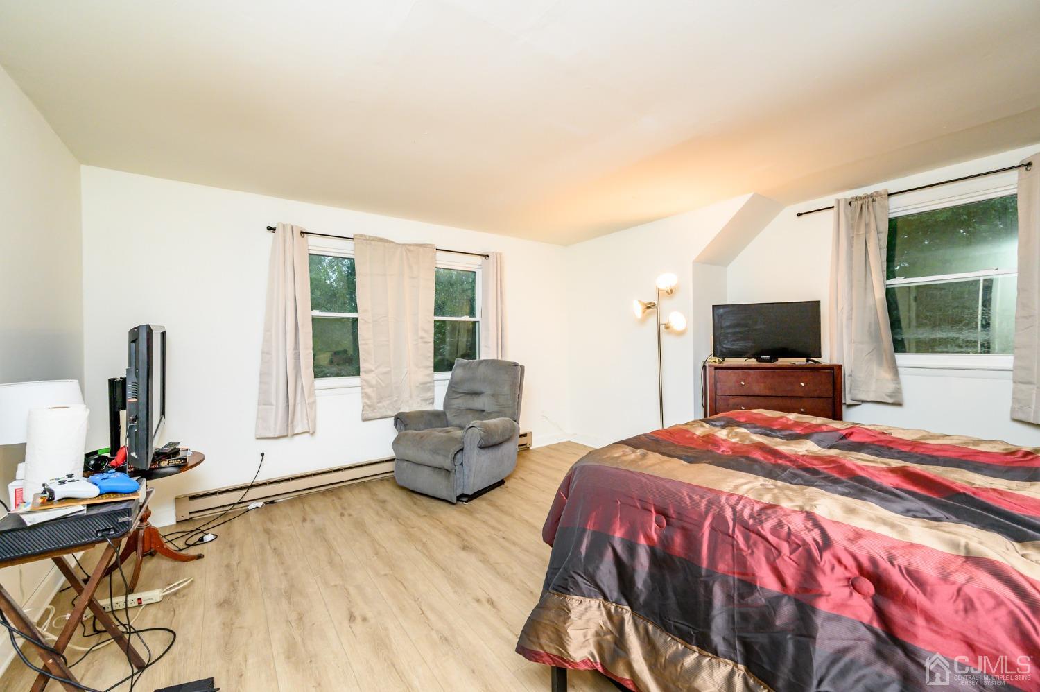 67 Hollow Road Glen Gardner, NJ 08826 - Photo 33 of 45 a bedroom with a bed and large windows