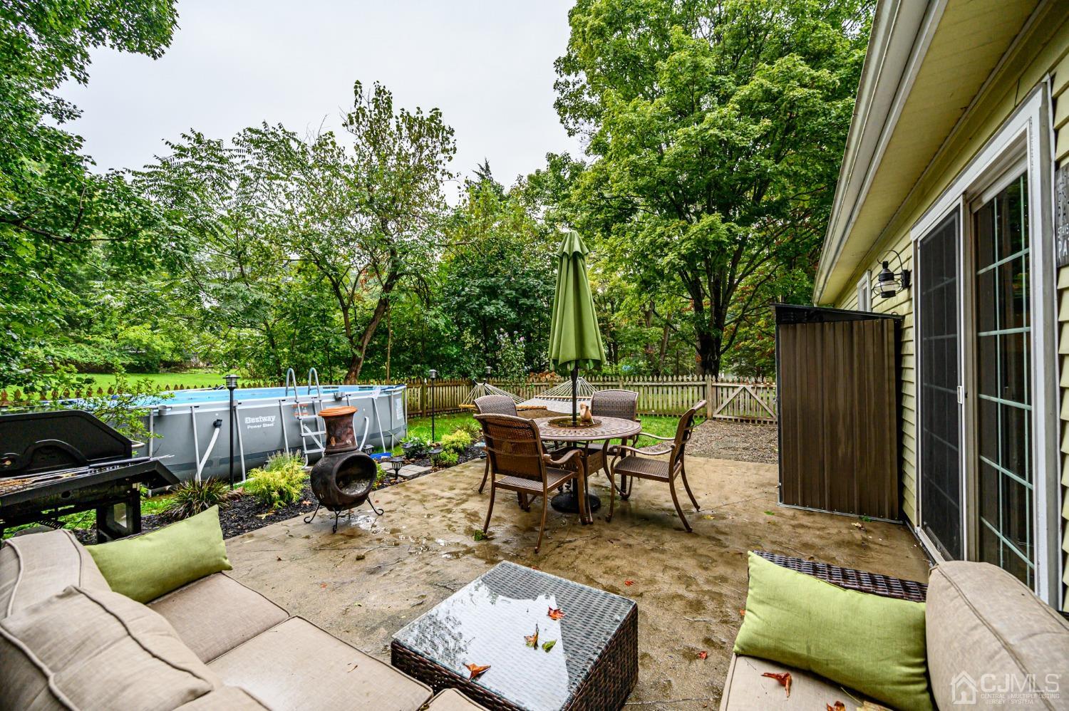 67 Hollow Road Glen Gardner, NJ 08826 - Photo 39 of 45 a view of a patio with couches chairs and a table and chairs with wooden fence