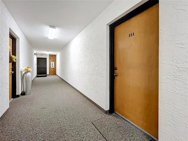a view of a hallway with space and balcony