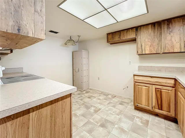 a kitchen with stainless steel appliances granite countertop a sink and a stove top oven