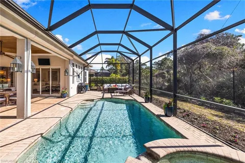 a bathroom with a granite countertop sink toilet and mirror