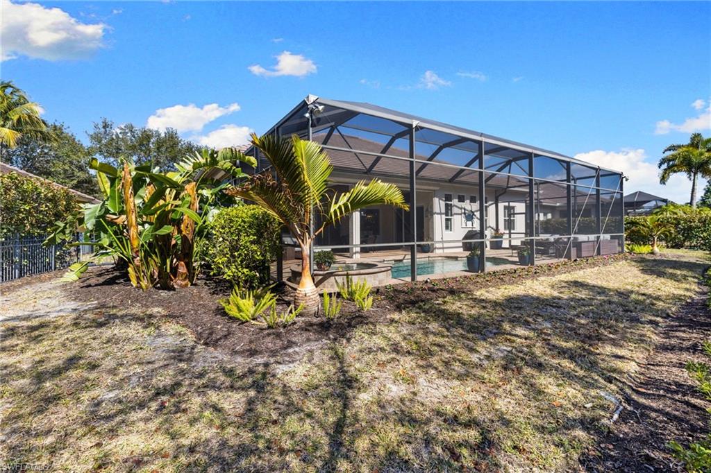 347 Saddlebrook Lane Naples, FL 34110 - Photo 36 of 44 a view of a house with a backyard
