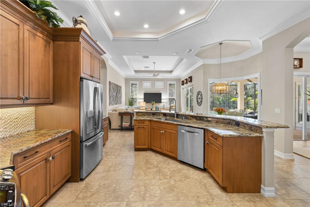 347 Saddlebrook Lane Naples, FL 34110 - Photo 8 of 44 a large kitchen with stainless steel appliances granite countertop a refrigerator and a sink