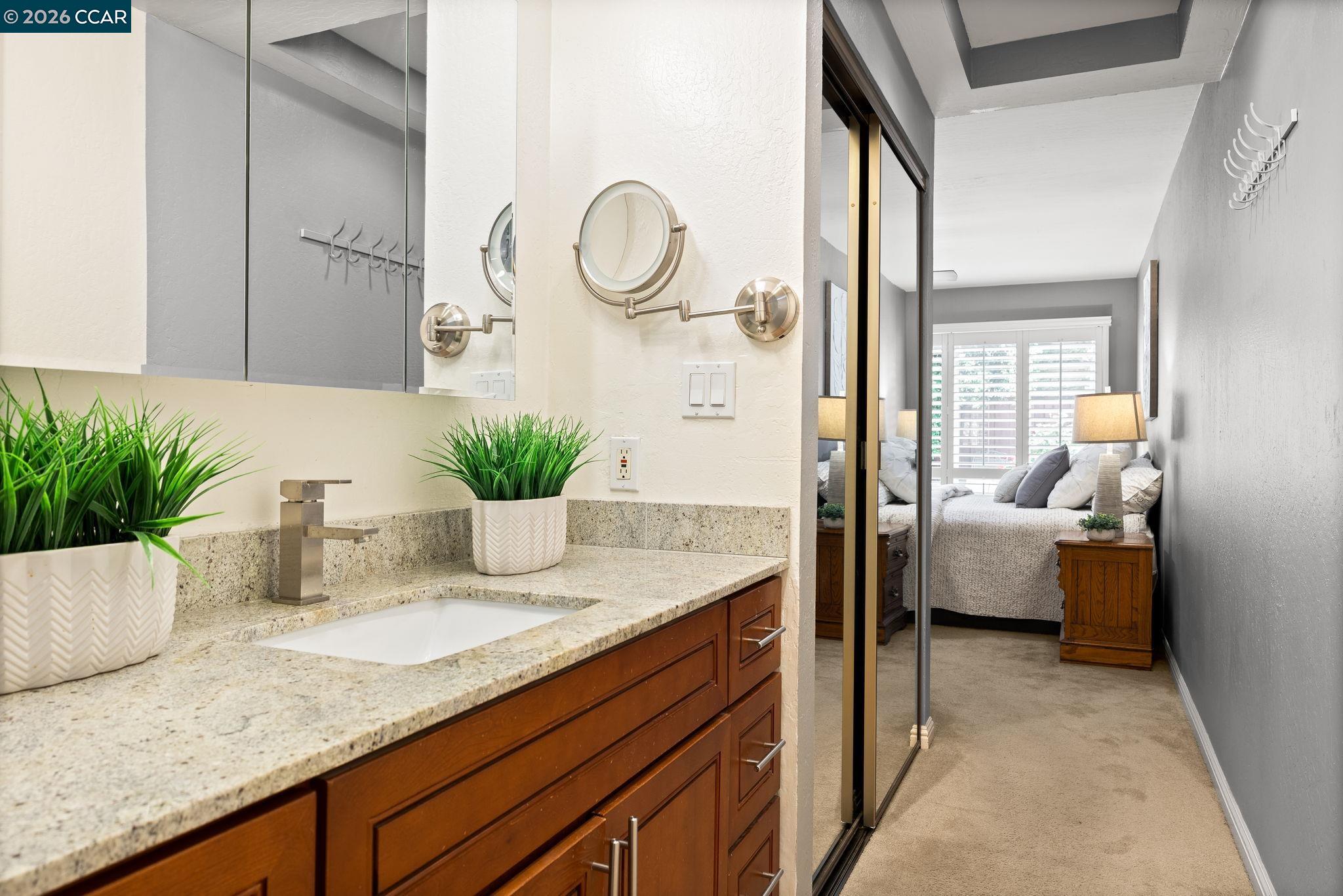 2095 Robb Road Walnut Creek, CA 94596 - Photo 10 of 26 a bathroom with a granite countertop sink a mirror and a shower