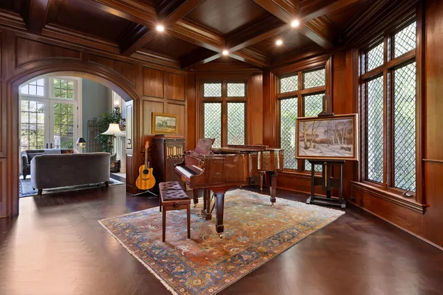 a living room with furniture a rug and a large window