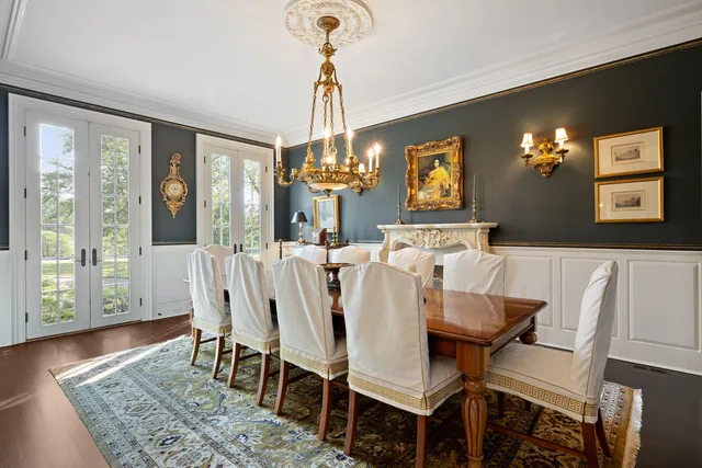 a view of a dining room with furniture wooden floor and chandelier