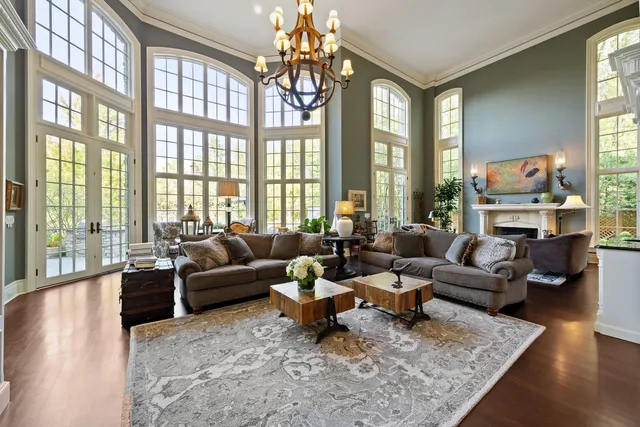 a living room with fireplace furniture and a large window
