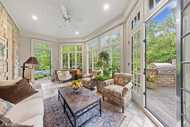 a living room with furniture and large windows