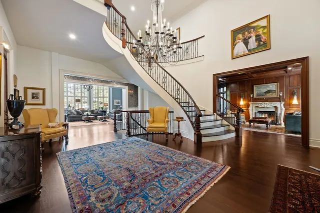 a living room with furniture and a chandelier