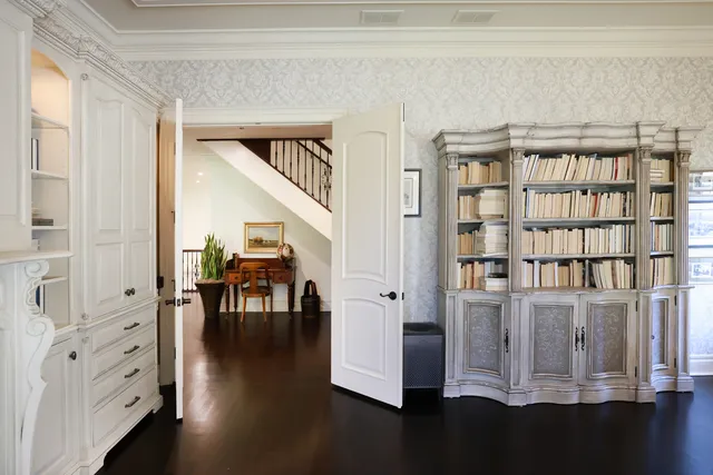 a view of front door with workspace and wooden floor
