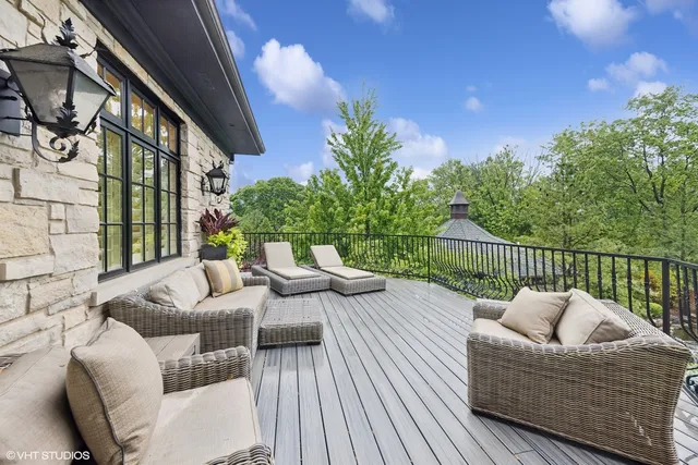 a balcony with furniture and a potted plant