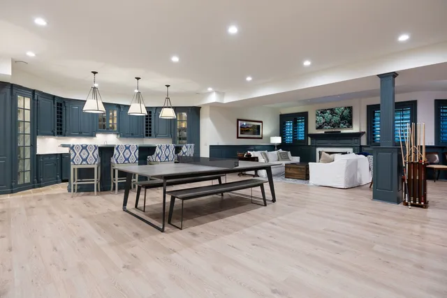 a living room with furniture a rug and kitchen view