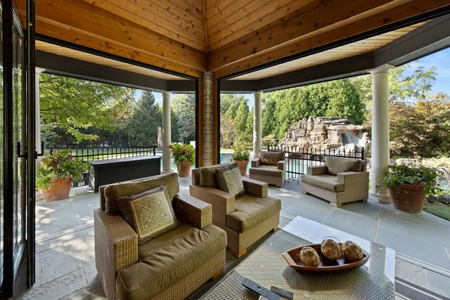 a living room with furniture and a floor to ceiling window