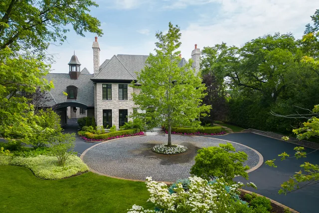a view of a house with a yard and potted plants