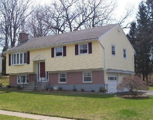 135 Meadowlawn Road Stratford, CT 06614 - Photo 1 of 1 a front view of a house with a garden and yard