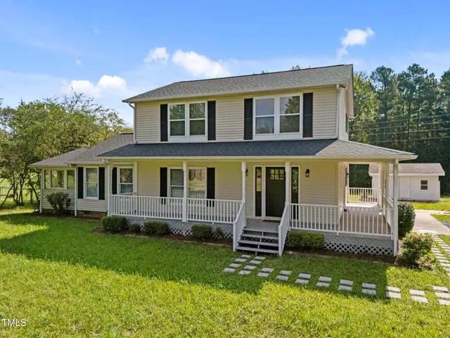 a front view of a house with a yard table and chairs