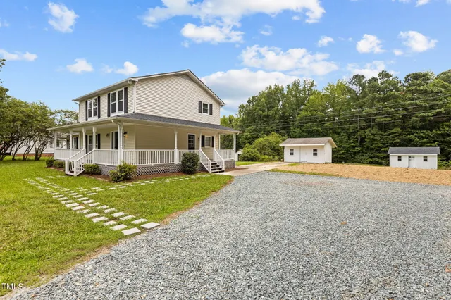 a view of house with a yard