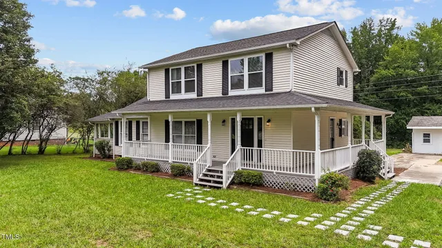 a view of a house with a bed and wooden fence