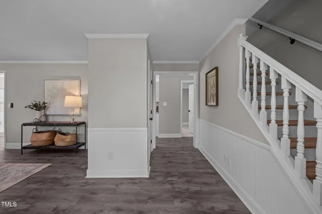 a view of a livingroom with furniture and staircase