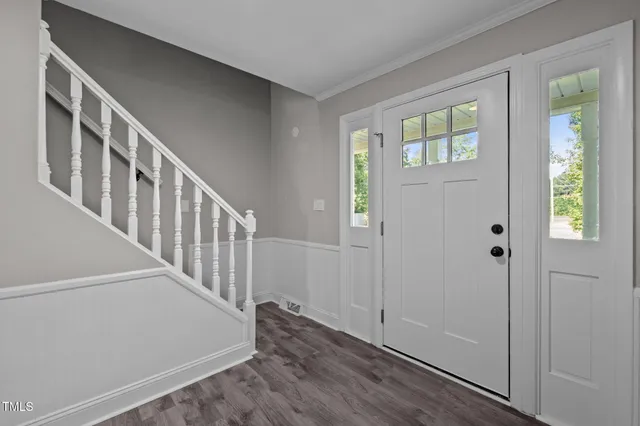 a view of an entryway with wooden floor