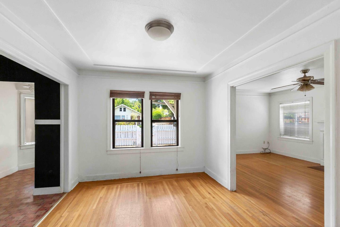 16735 Shannon Road Los Gatos, CA 95032 - Photo 4 of 19 an empty room with wooden floor and windows