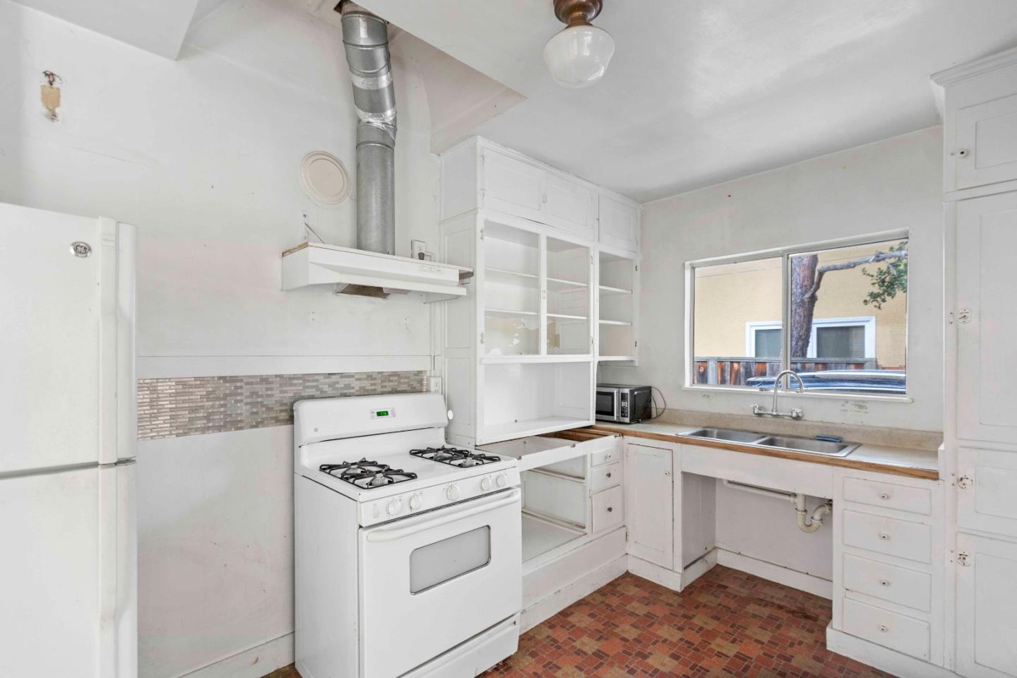 16735 Shannon Road Los Gatos, CA 95032 - Photo 6 of 19 a kitchen with cabinets appliances a sink and a window