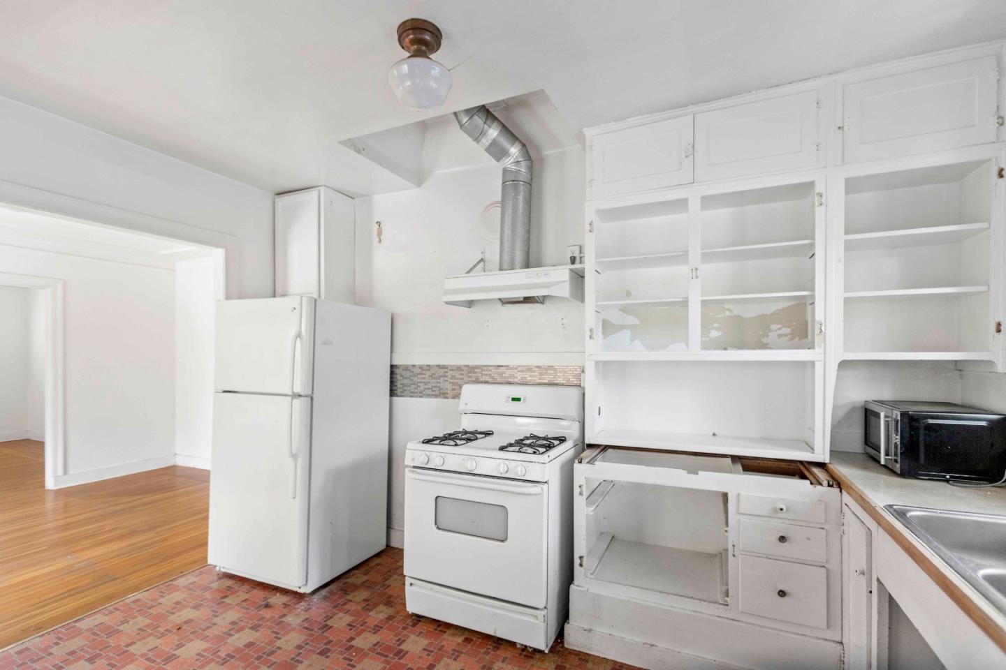 16735 Shannon Road Los Gatos, CA 95032 - Photo 7 of 19 a kitchen with white cabinets and white appliances