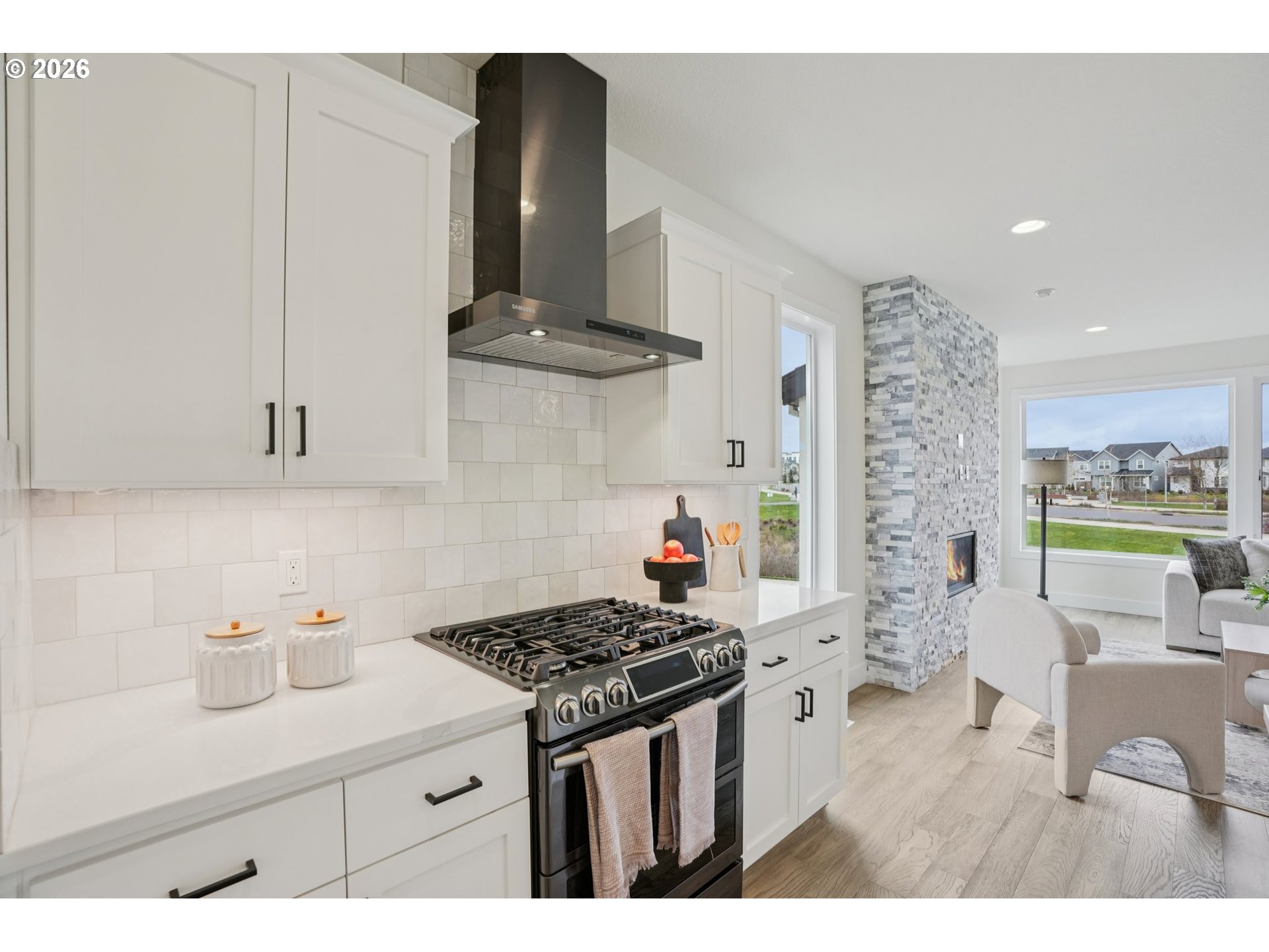 3809 Southeast Reed Drive Hillsboro, OR 97123 - Photo 11 of 40 a kitchen with stainless steel appliances a stove a sink and white cabinets